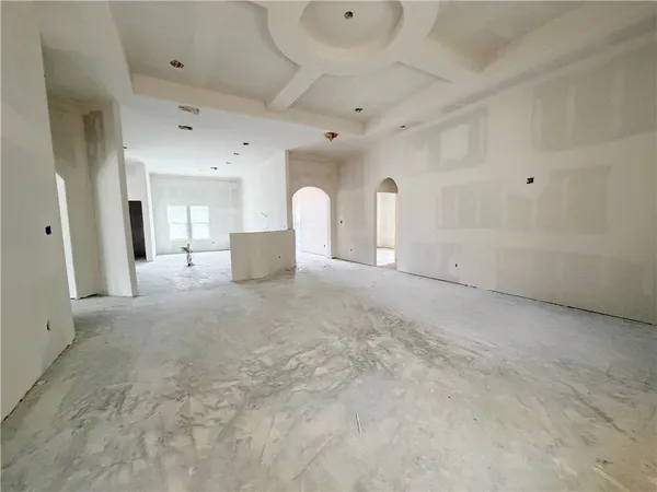 a view of a livingroom with furniture and staircase