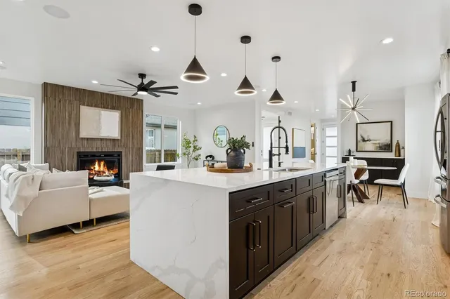 a large kitchen with cabinets and wooden floor