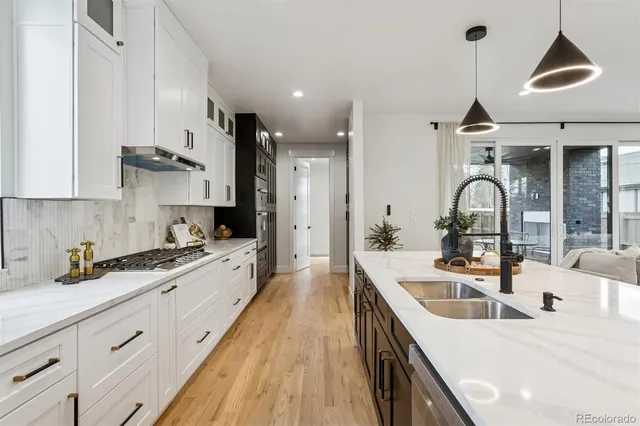 a kitchen with a sink stove and cabinets