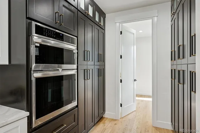 a kitchen with granite countertop cabinets and steel stainless steel appliances