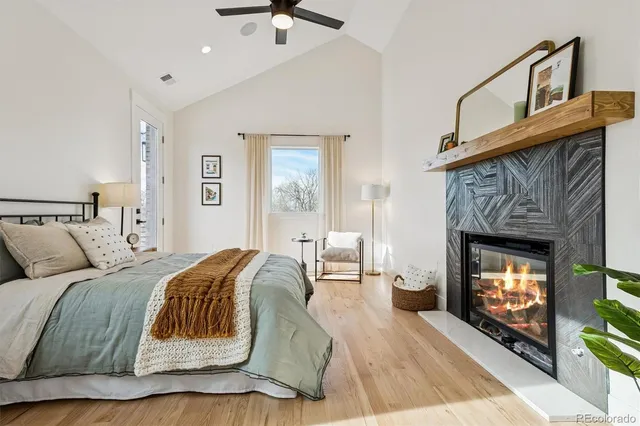 a spacious bedroom with a bed a fireplace and a couch