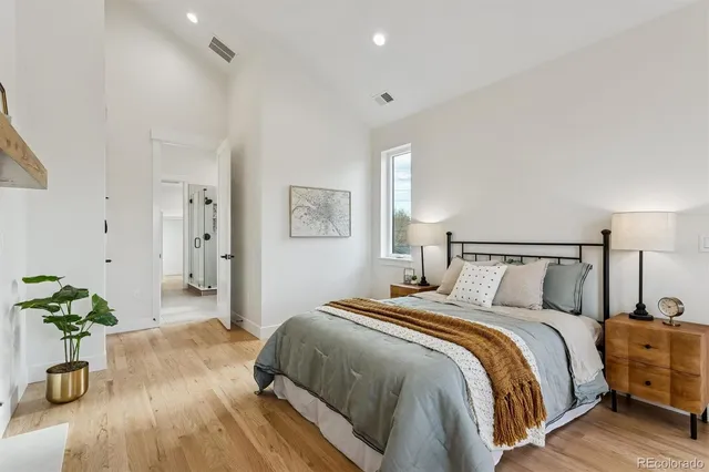 a bedroom with a bed and a potted plant