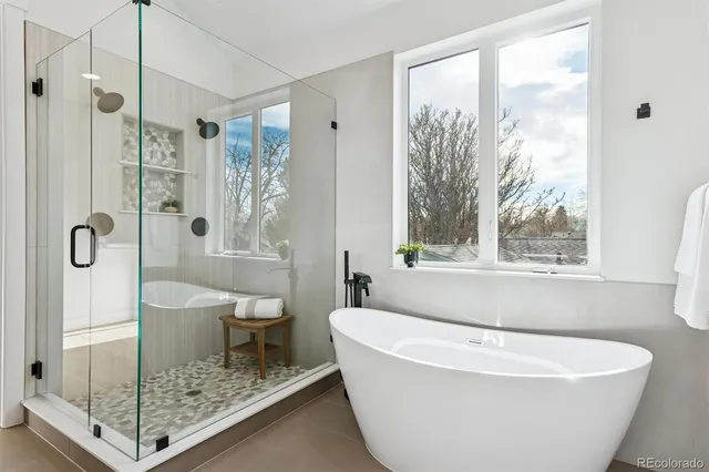 a white bath tub sitting next to a shower