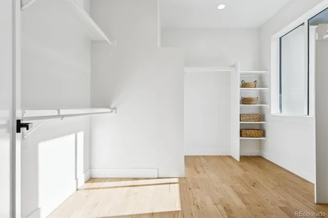 a view of walk in closet with empty racks