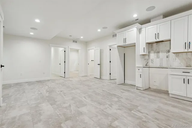 a view of a kitchen with white cabinets
