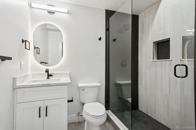 a bathroom with a sink a toilet and a mirror