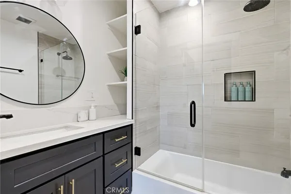 a bedroom with a large bed and a couch