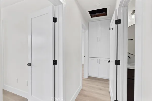 a large bedroom with a bed and wooden floor