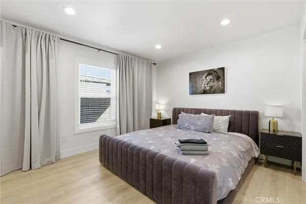 a bedroom with a bed and a night stand