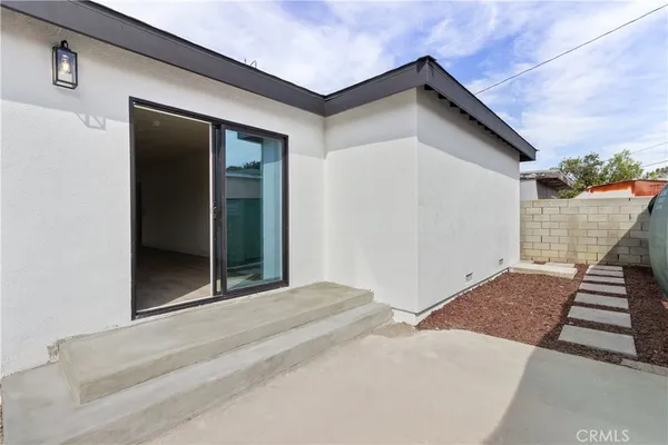a living room with furniture a flat screen tv and a window