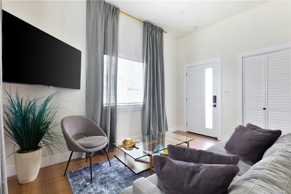a dining room with furniture and wooden floor