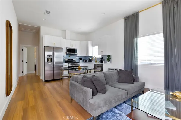 a kitchen with stainless steel appliances a stove a microwave a sink and cabinets