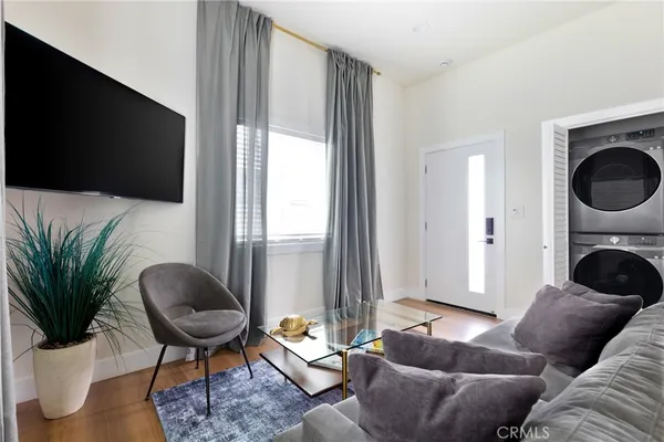 a bedroom with a bed potted plant with the wooden floor
