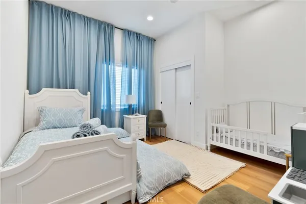 a bedroom with a bed and a chair in it