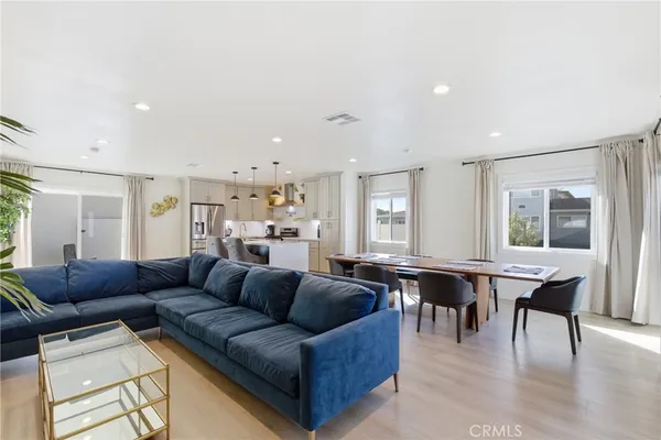 a large kitchen with lots of counter top space and stainless steel appliances