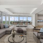 a living room with furniture wooden floor and a large window