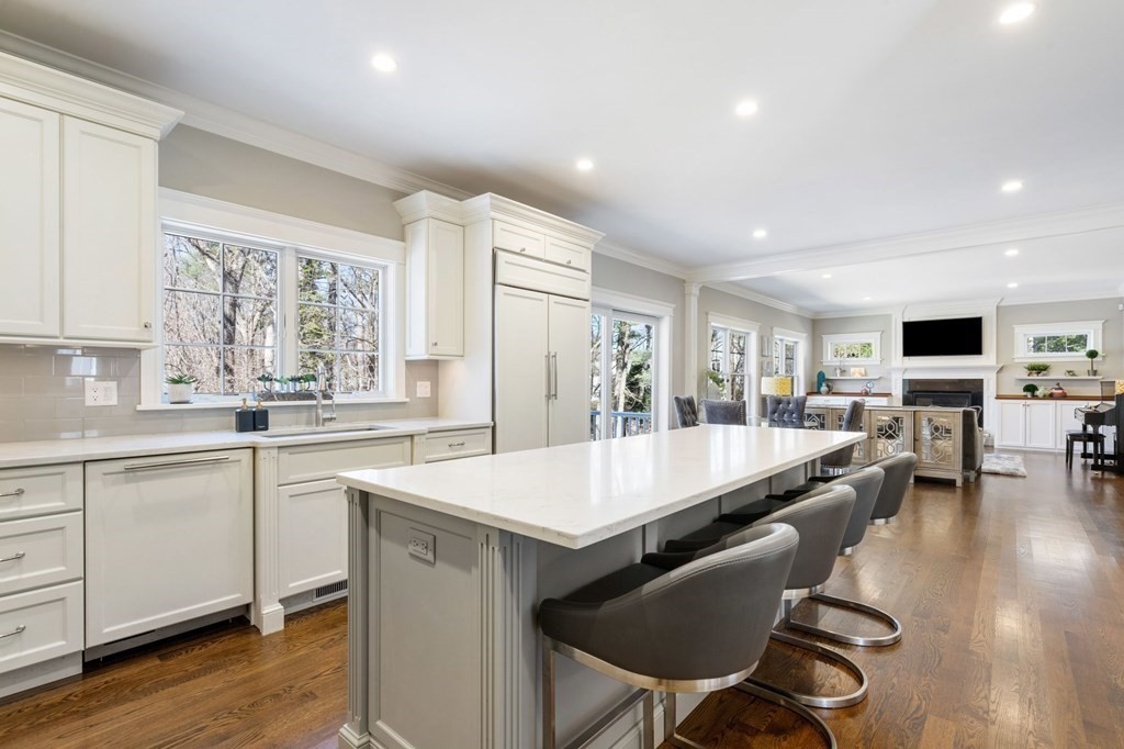 43 MacArthur Road Wellesley, MA 02482 - Photo 11 of 35 a large kitchen with kitchen island a large island in it