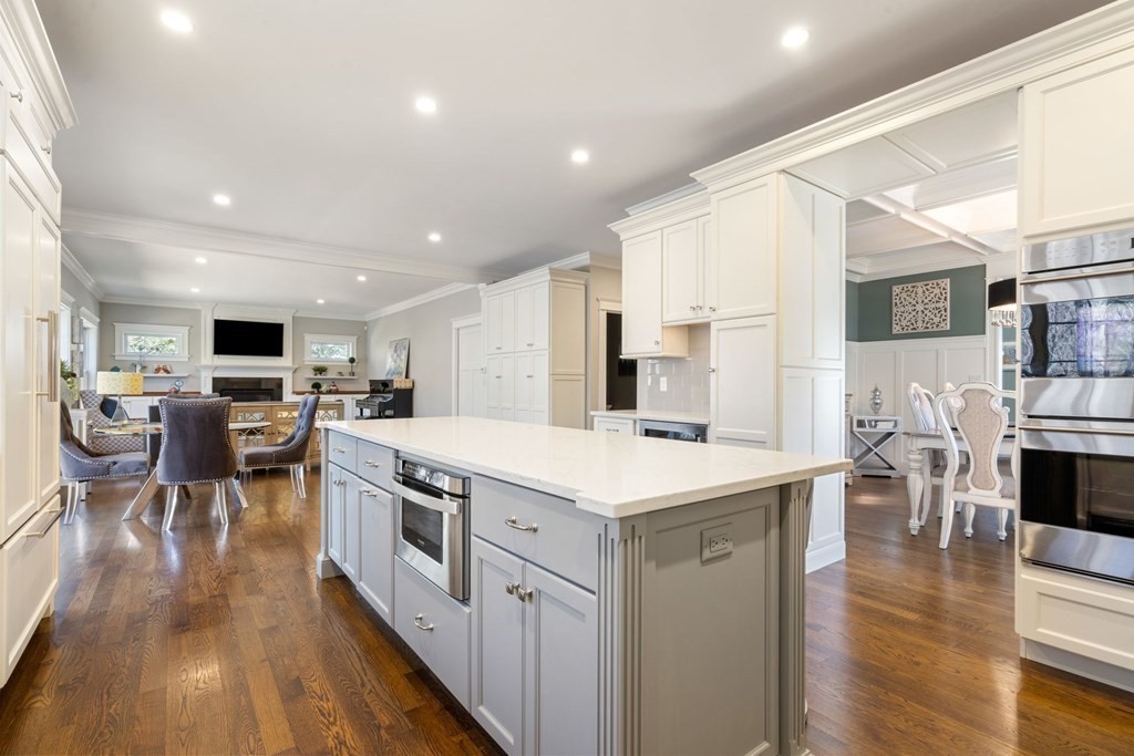 43 MacArthur Road Wellesley, MA 02482 - Photo 13 of 35 a kitchen with stainless steel appliances kitchen island granite countertop a stove top oven a sink a dining table and chairs