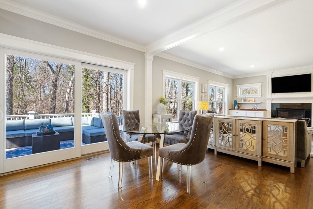 43 MacArthur Road Wellesley, MA 02482 - Photo 14 of 35 a dining room with furniture a fireplace and wooden floor