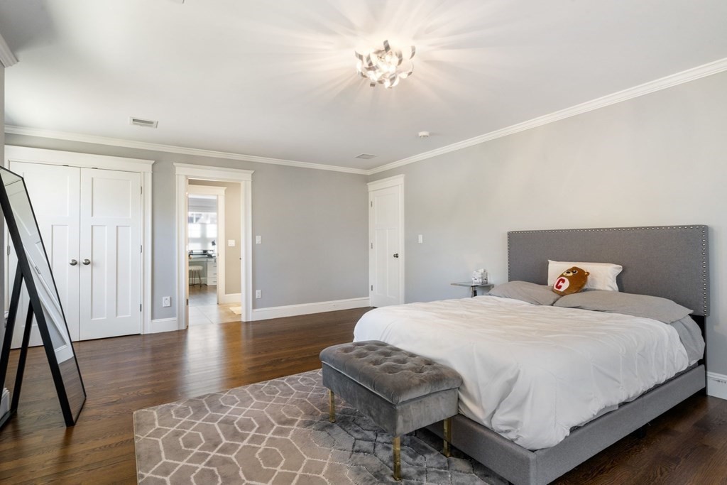 43 MacArthur Road Wellesley, MA 02482 - Photo 25 of 35 a bedroom with a bed and wooden floor