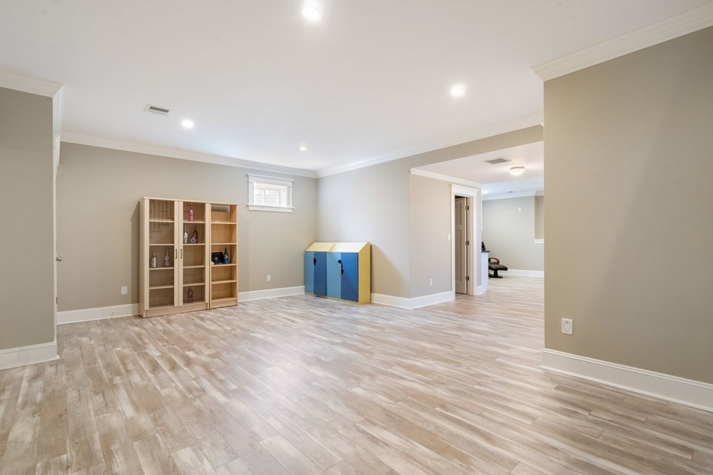 43 MacArthur Road Wellesley, MA 02482 - Photo 27 of 35 a view of an empty room with wooden floor and a window