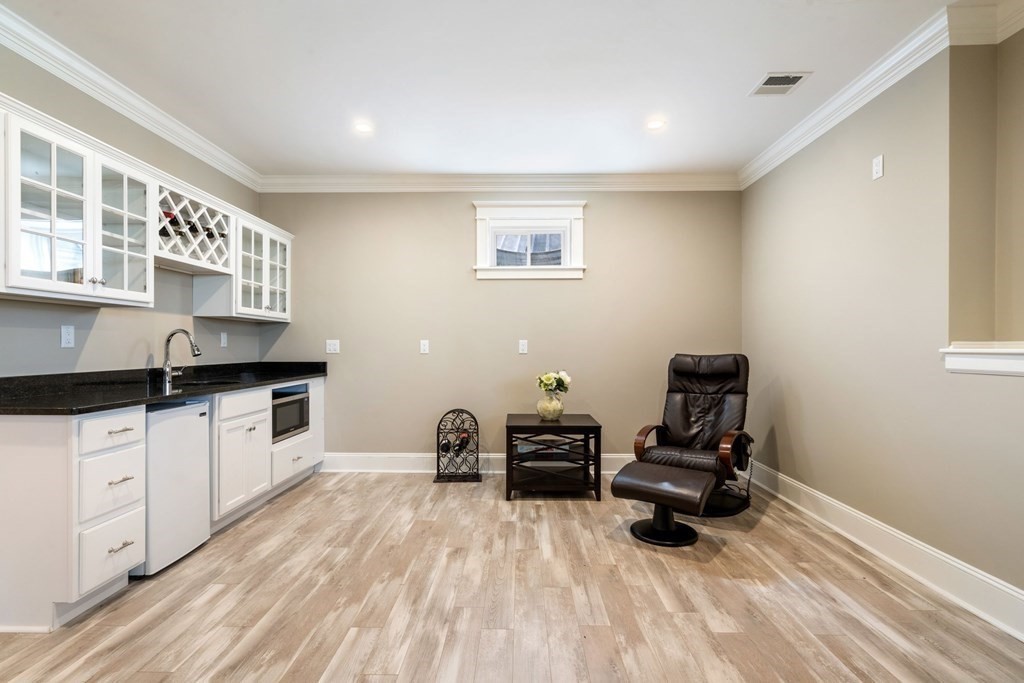 43 MacArthur Road Wellesley, MA 02482 - Photo 28 of 35 a kitchen with granite countertop a sink cabinets and wooden floor