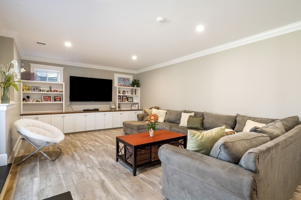 43 MacArthur Road Wellesley, MA 02482 - Photo 29 of 35 a living room with furniture and a flat screen tv