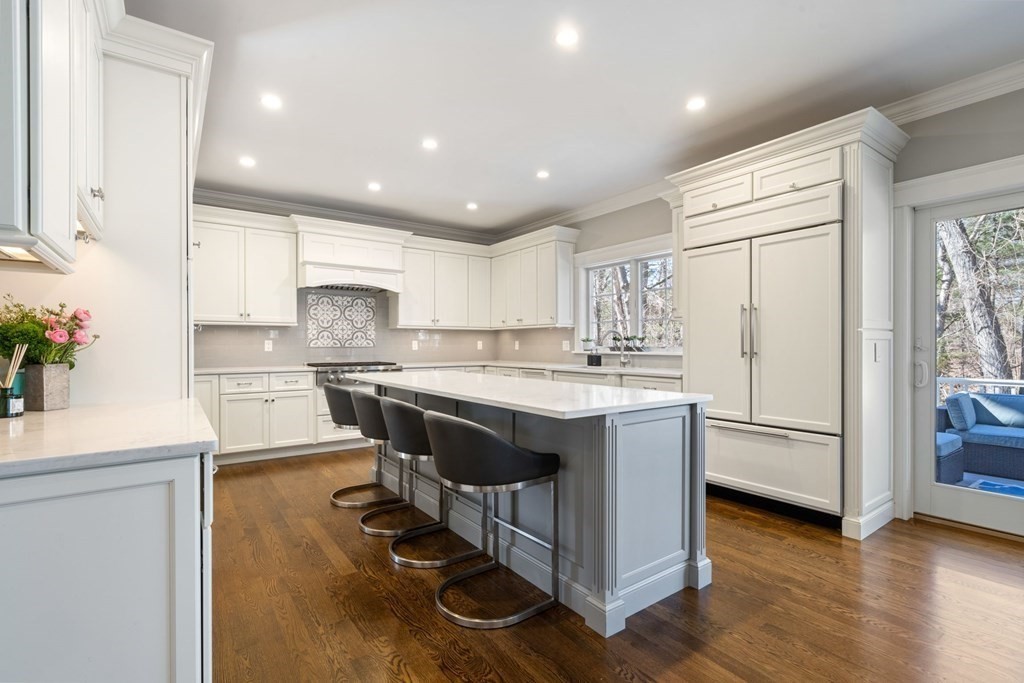 43 MacArthur Road Wellesley, MA 02482 - Photo 8 of 35 a kitchen with kitchen island white cabinets and stainless steel appliances