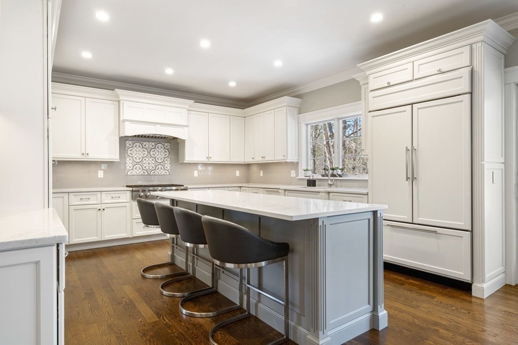 43 MacArthur Road Wellesley, MA 02482 - Photo 9 of 35 a kitchen with kitchen island a sink cabinets and wooden floor