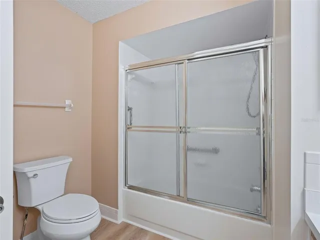 a bathroom with a shower a toilet and a sink