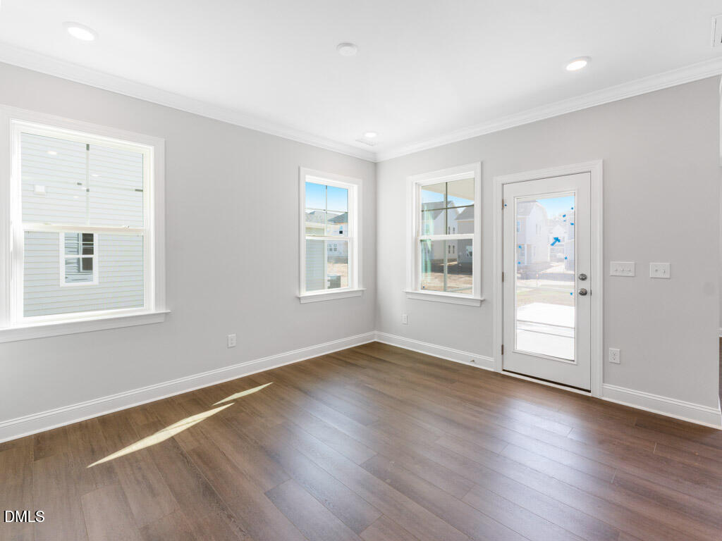 348 Canyon Gap Way Raleigh, NC 27610 - Photo 11 of 33 a view of an empty room with wooden floor and a window