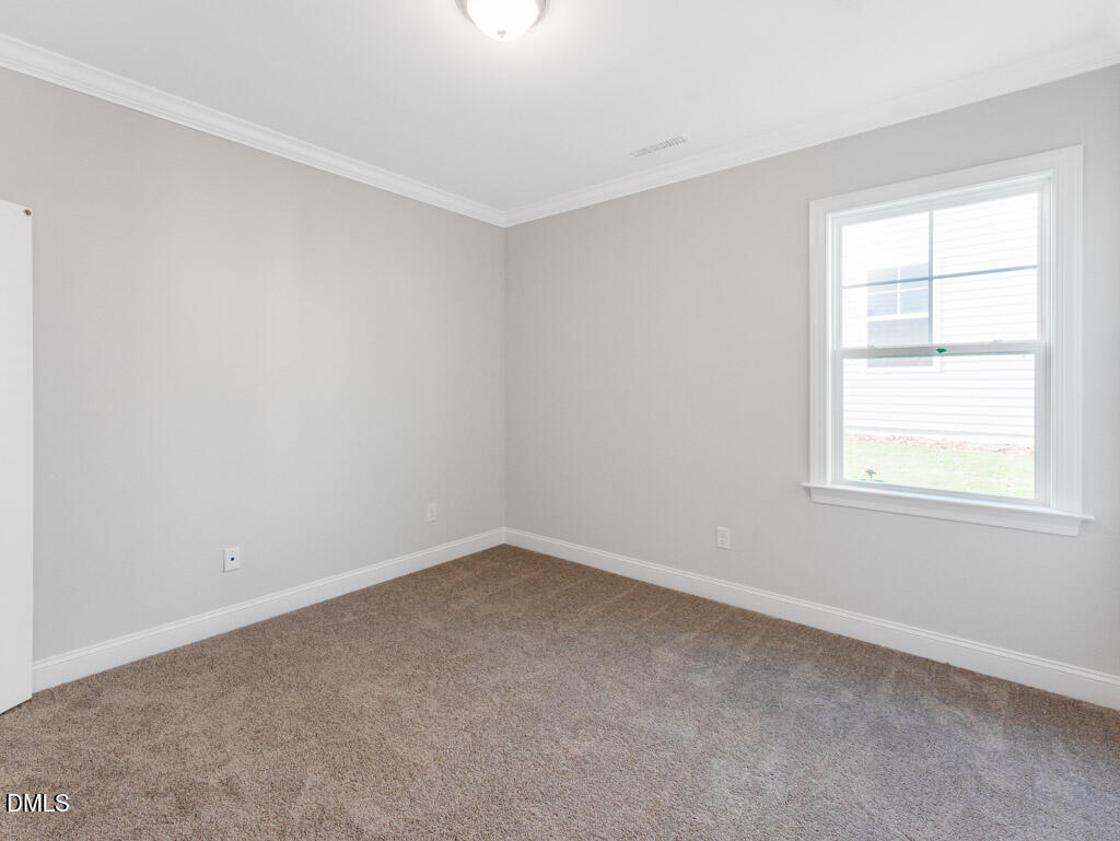 348 Canyon Gap Way Raleigh, NC 27610 - Photo 13 of 33 an empty room with a window