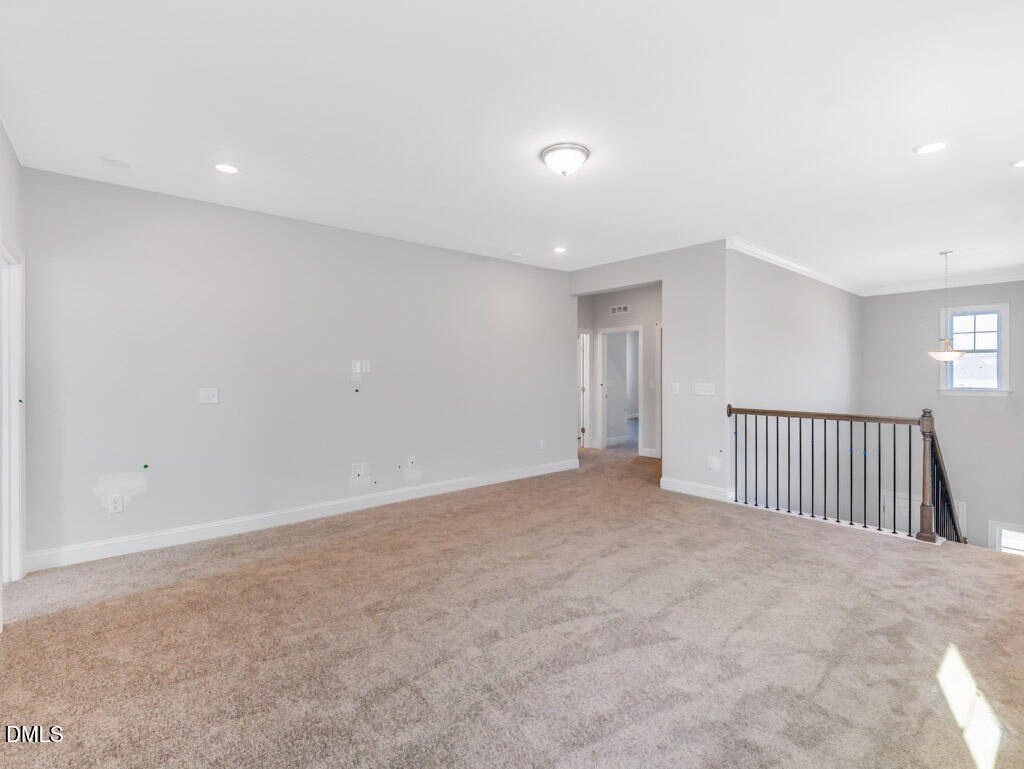 348 Canyon Gap Way Raleigh, NC 27610 - Photo 17 of 33 an empty room with staircase