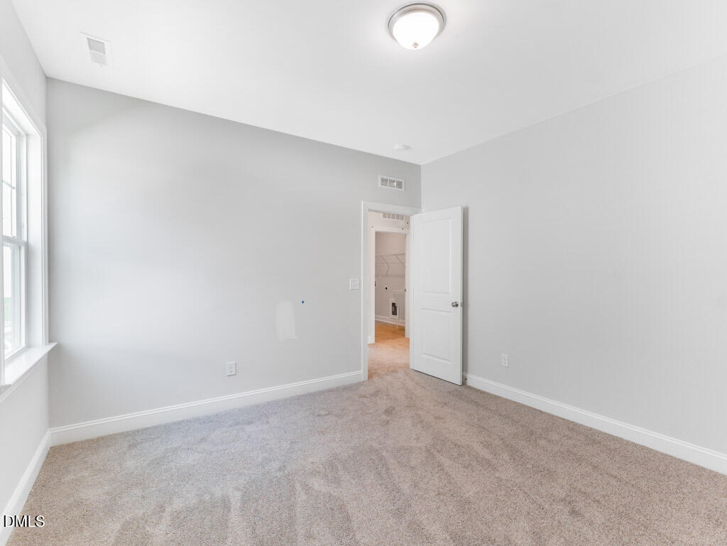 348 Canyon Gap Way Raleigh, NC 27610 - Photo 24 of 33 an empty room with an entryway