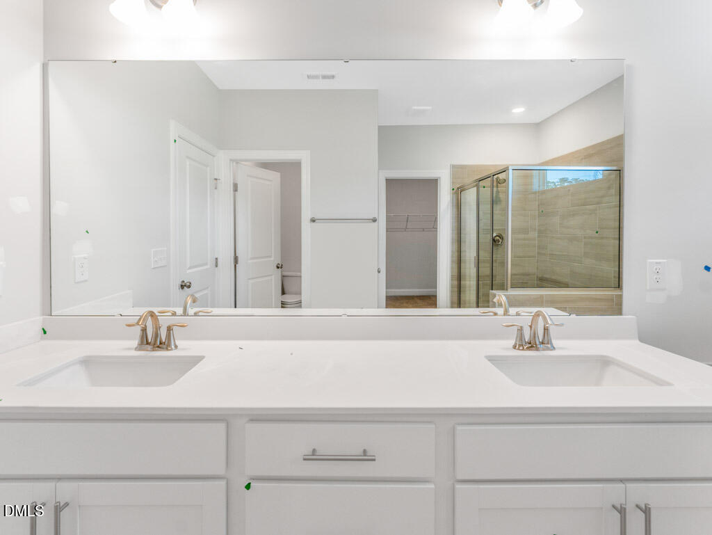 348 Canyon Gap Way Raleigh, NC 27610 - Photo 27 of 33 a bathroom with a sink and a mirror