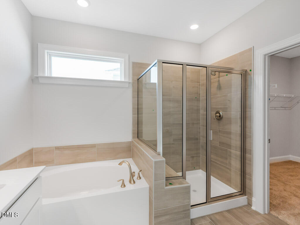 348 Canyon Gap Way Raleigh, NC 27610 - Photo 29 of 33 a bathroom with a bathtub and a shower