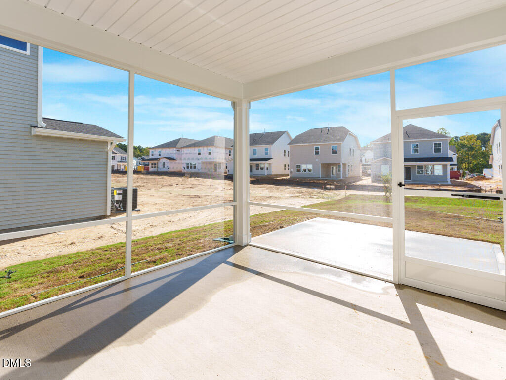 348 Canyon Gap Way Raleigh, NC 27610 - Photo 32 of 33 a view of a living room and a floor to ceiling window