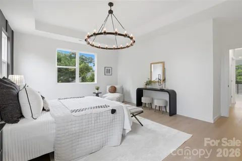 a bed room with a bed and a chandelier