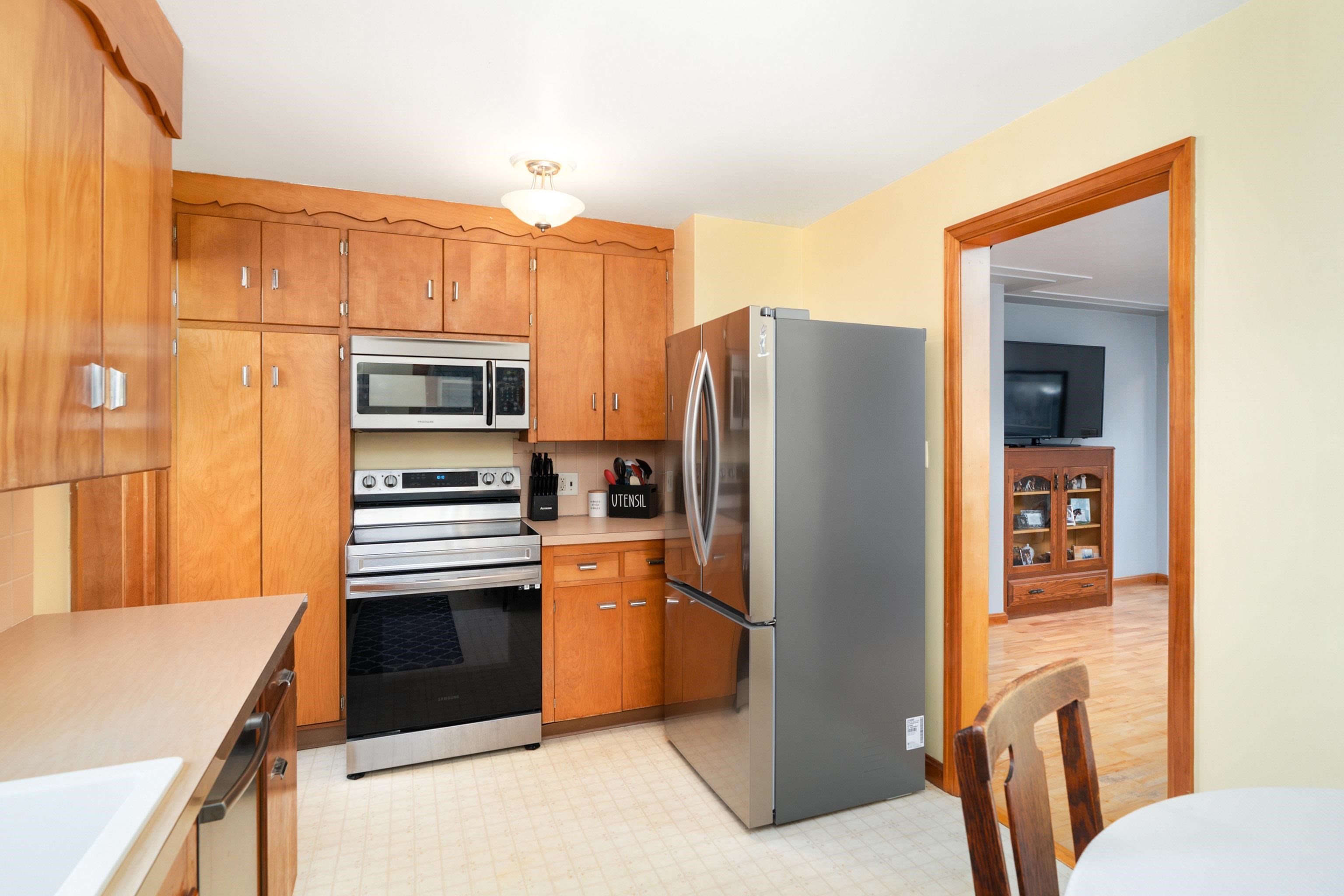 4621 Oneida Street Duluth, MN 55804 - Photo 12 of 47 Kitchen with appliances with stainless steel finishes, light countertops, brown cabinets, and light floors