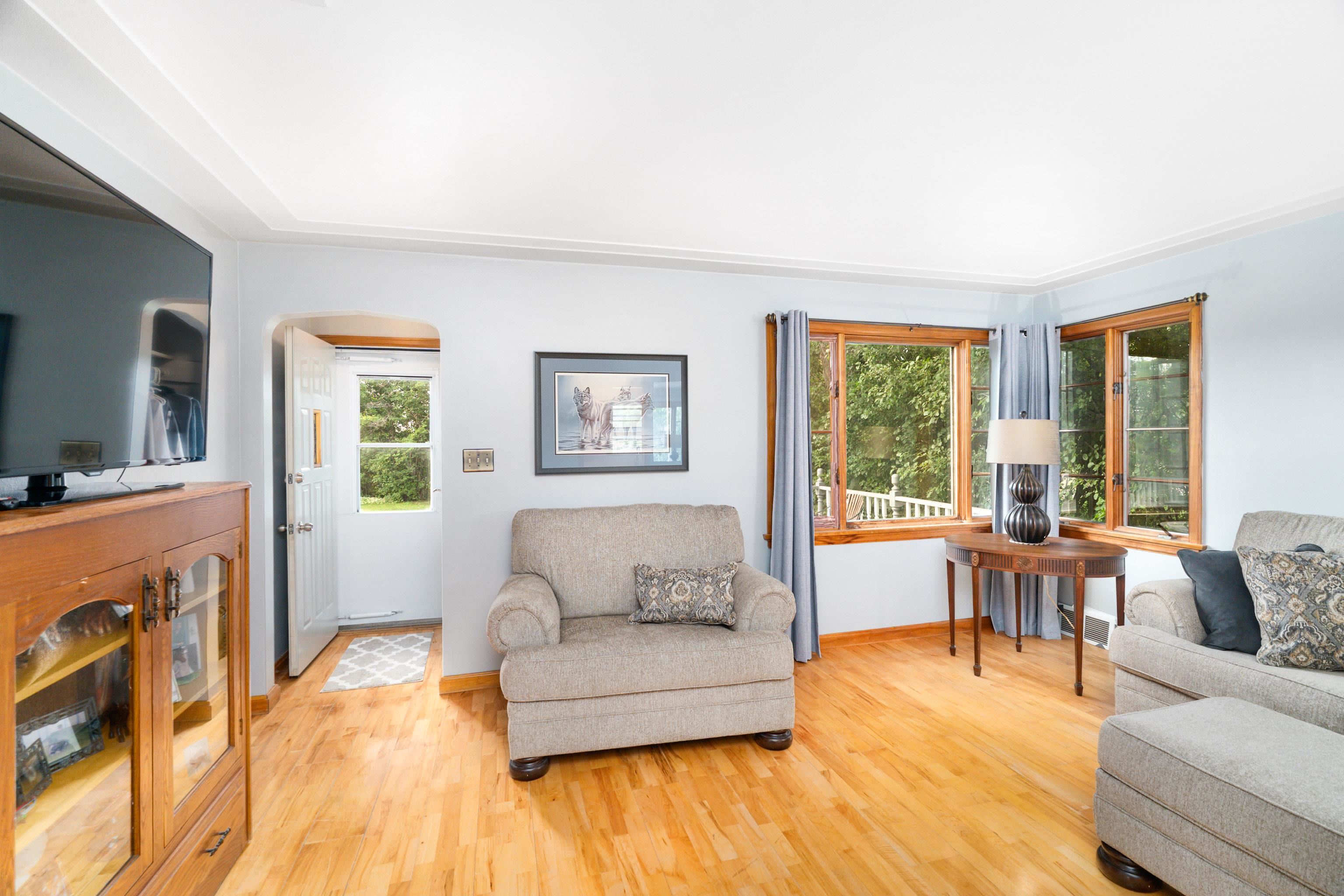 Living area with wood finished floors and arched walkways