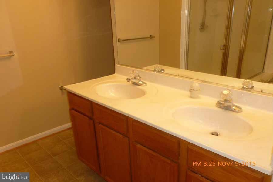 1908 Gardenia Court Odenton, MD 21113 - Photo 22 of 23 a bathroom with a sink and a mirror