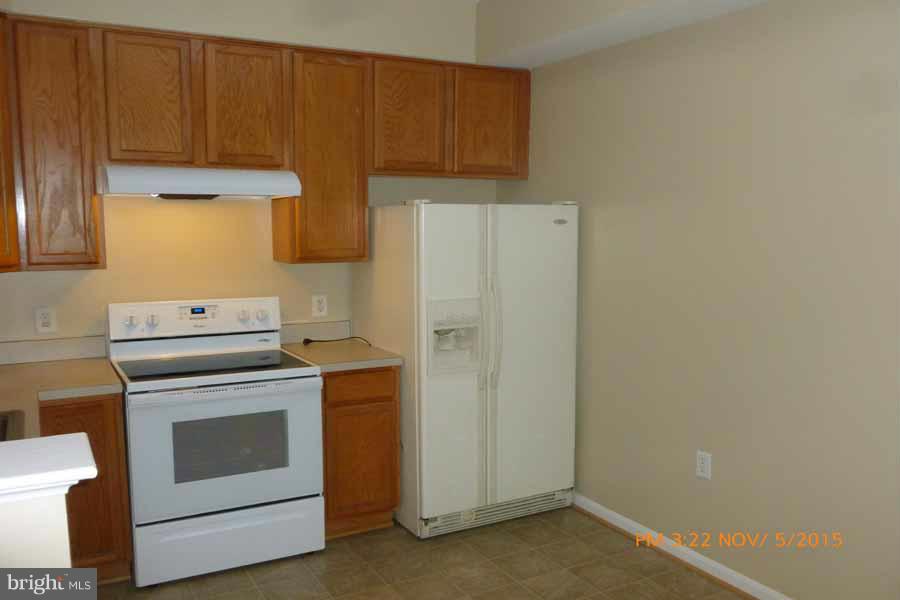 1908 Gardenia Court Odenton, MD 21113 - Photo 10 of 23 a kitchen with a stove and a refrigerator
