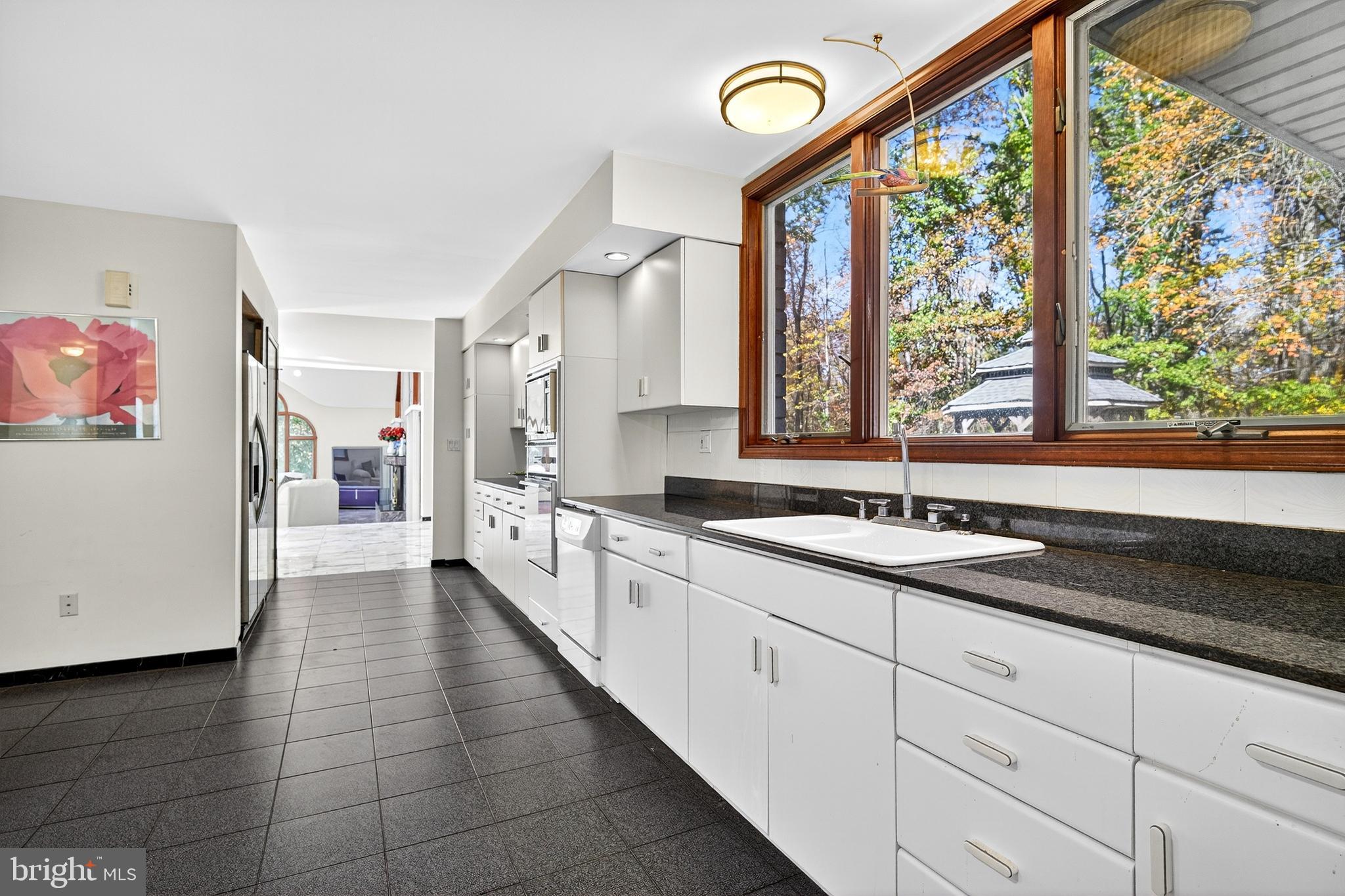 16 Benedek Road Princeton, NJ 08540 - Photo 18 of 60 a large white kitchen with granite countertop a large window and a sink