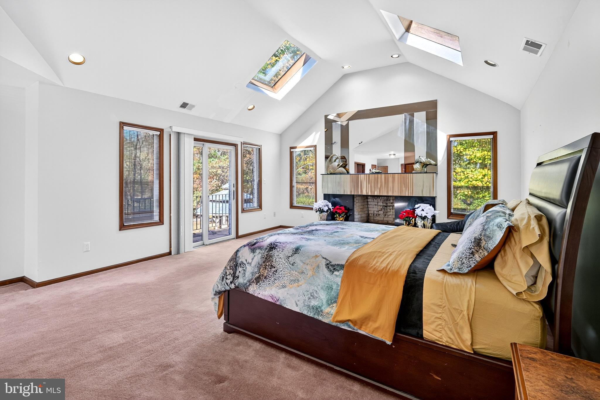 16 Benedek Road Princeton, NJ 08540 - Photo 33 of 60 a bed sitting in a spacious bedroom next to a window and a flat screen tv