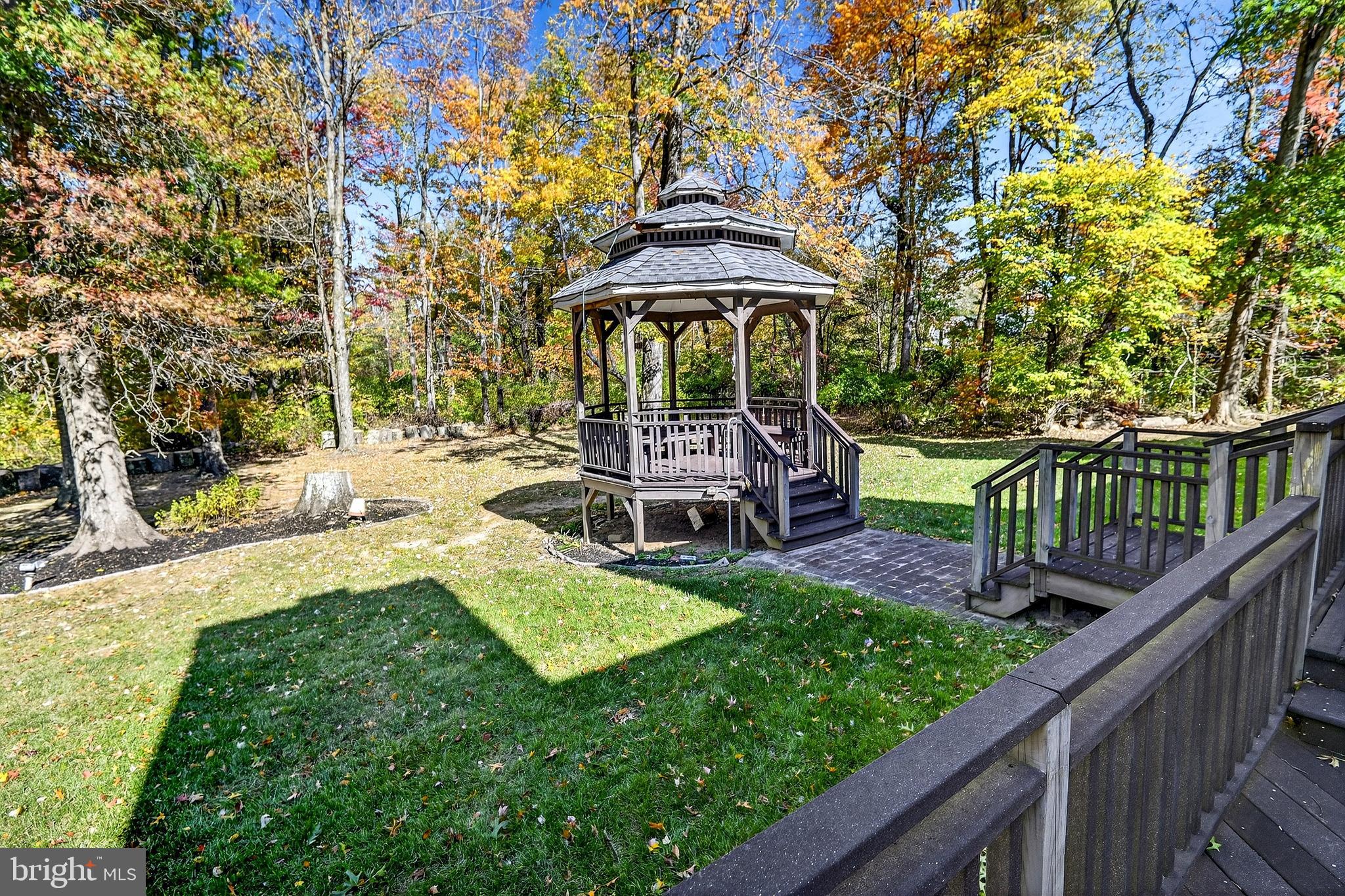 16 Benedek Road Princeton, NJ 08540 - Photo 49 of 60 a view of a patio with a table chairs and a fire pit