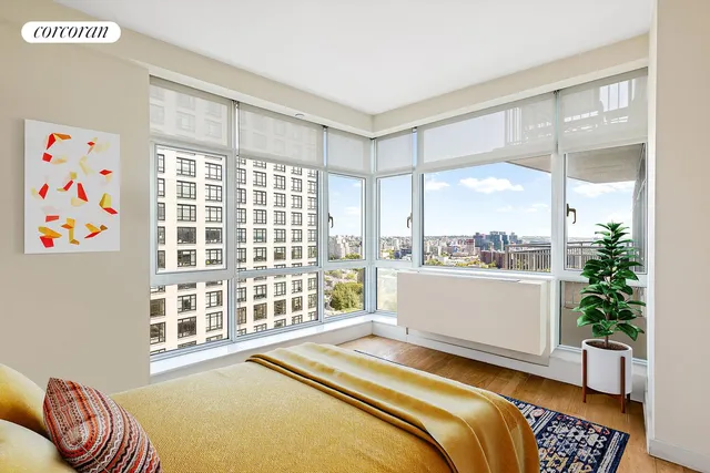 a bedroom with a bed and a large window with outer view