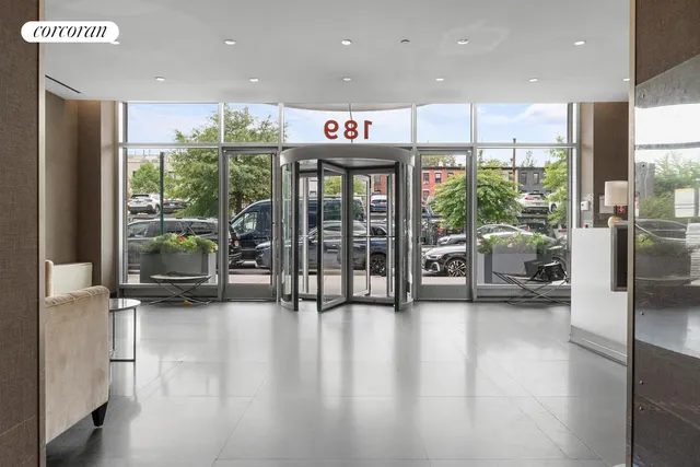 a hallway with a large window and stainless steel appliances