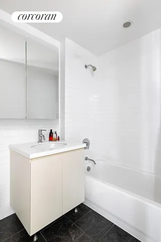 a living room with furniture a rug and a window