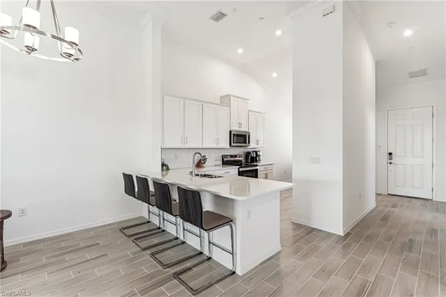 a kitchen with stainless steel appliances a sink a stove a refrigerator and cabinets