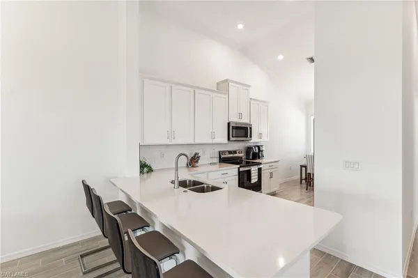 a kitchen with a dining table chairs and refrigerator